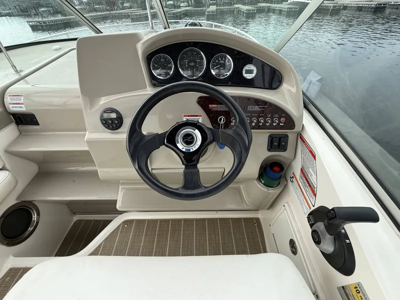 Slide: The Image of The image shows the helm of a 2007 Sea Ray 240 Sundancer with multiple gauges. - 9