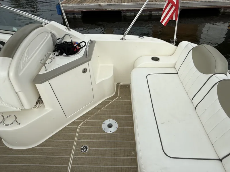 Slide: The Image of The image shows the cockpit of a 2007 Sea Ray 240 Sundancer with white seating and a dock in the background. - 5