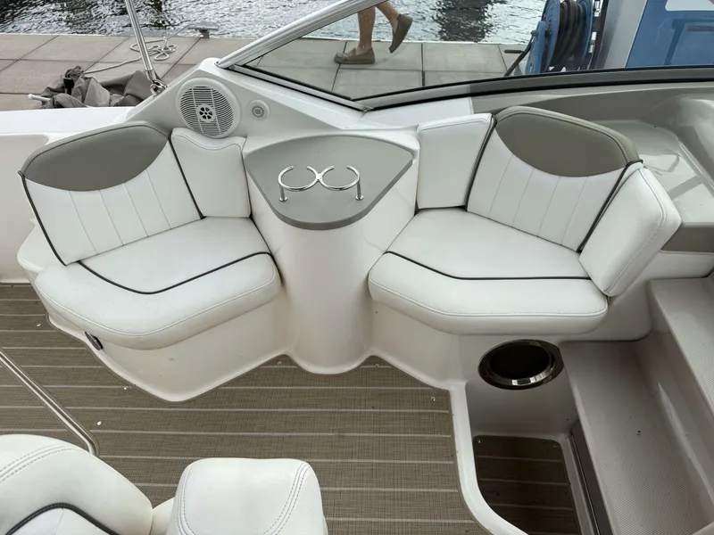 Slide: The Image of The 2007 Sea Ray 240 Sundancer features an elegant seating area with white upholstery and cup holders. - 7