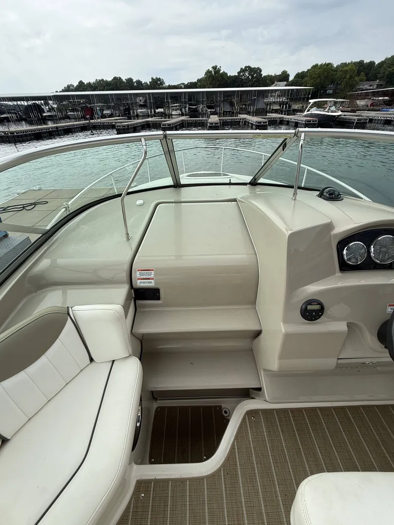 Slide: The Image of The image shows the cockpit of a 2007 Sea Ray 240 Sundancer with beige seating and dashboard. - 11