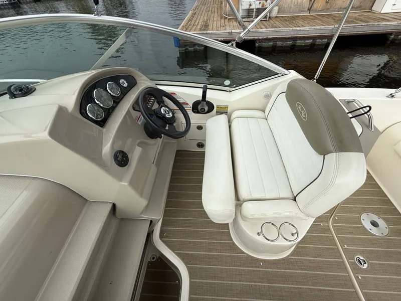 Slide: The Image of The image shows the cockpit of a 2007 Sea Ray 240 Sundancer with a sleek helm station. - 8