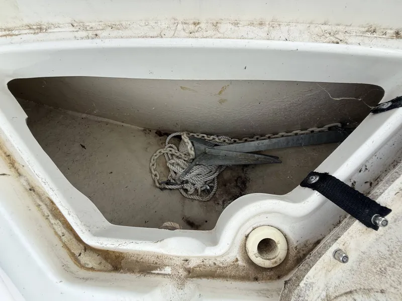 Slide: The Image of An anchor locker with an anchor and chain inside a boat. - 19