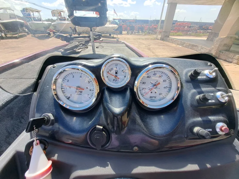 Slide: The Image of The image shows the dashboard of a 2022 Tracker Pro 170 boat with gauges and switches. - 7