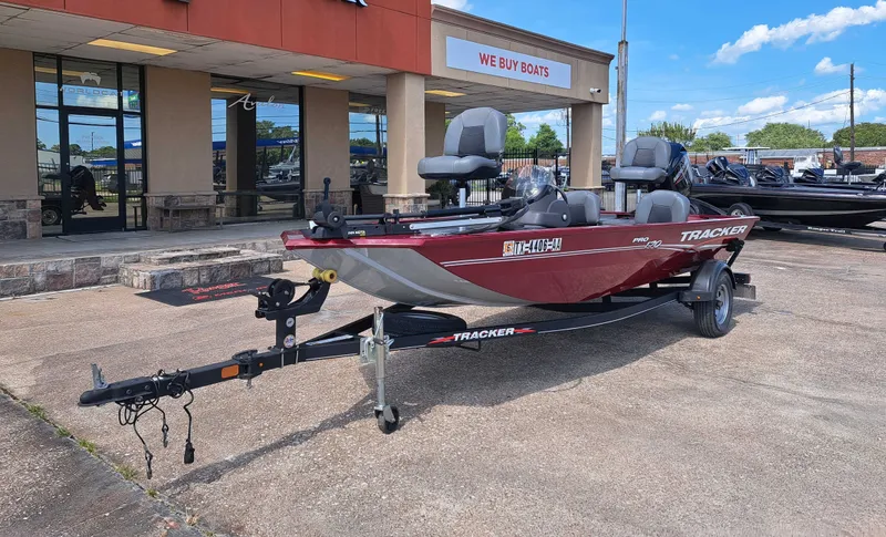 Slide: The Image of A red 2022 Tracker Pro 170 boat on a trailer in front of a store. - 8