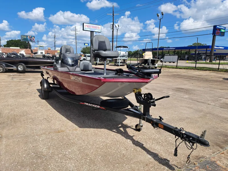 Slide: The Image of A 2022 Tracker Pro 170 boat on a trailer in a parking lot. It features a red exterior. - 9