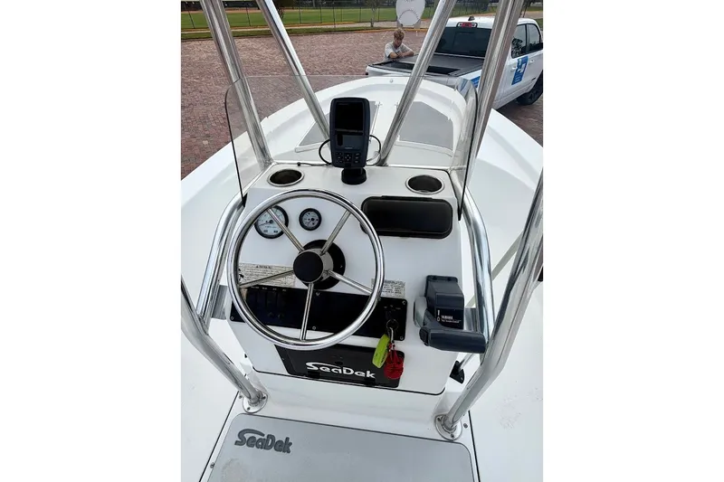 Slide: The Image of Center console of a 2016 Sportsman Island Bay 20 boat with steering wheel and controls. - 28