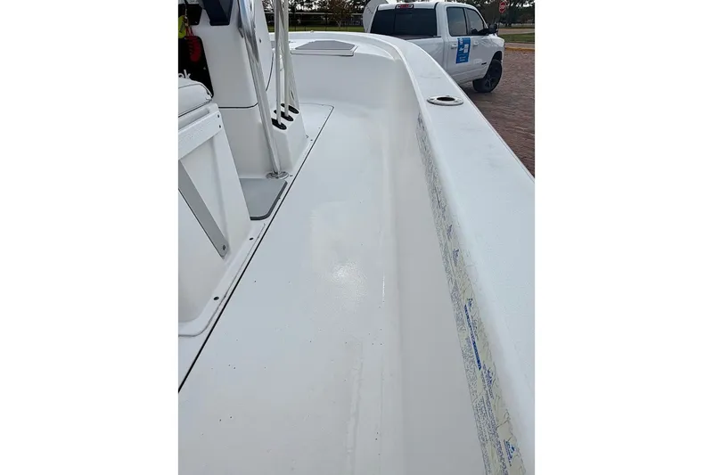 Slide: The Image of 2016 Sportsman Island Bay 20 boat interior with clean white deck and seating area. - 23
