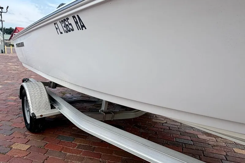 Slide: The Image of 2016 Sportsman Island Bay 20 boat on trailer, parked on brick pavement. - 8