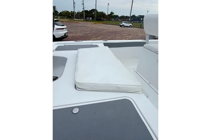 Slide: The Image of 2016 Sportsman Island Bay 20 boat deck with cushion, parked near vehicles. - 17