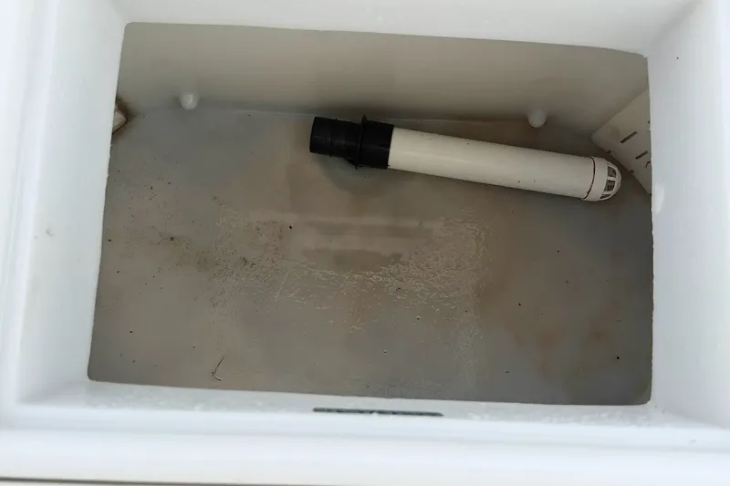 Slide: The Image of Empty compartment of 2016 Sportsman Island Bay 20 boat with a white drainage pipe. - 31