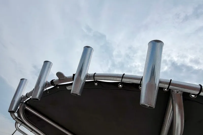 Slide: The Image of Rod holders on a 2016 Sportsman Island Bay 20 boat against a cloudy sky. - 27