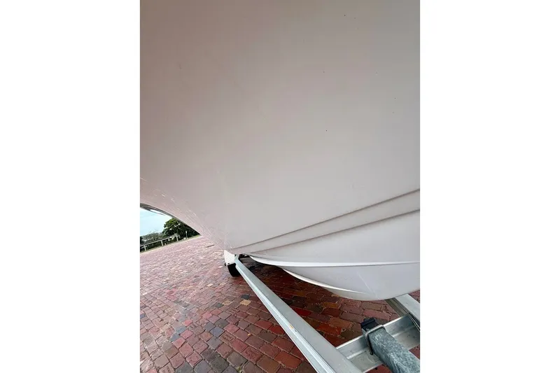 Slide: The Image of 2016 Sportsman Island Bay 20 boat hull on trailer, brick pavement background. - 7