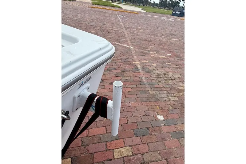 Slide: The Image of 2016 Sportsman Island Bay 20 boat on brick pavement with white pole and strap. - 9
