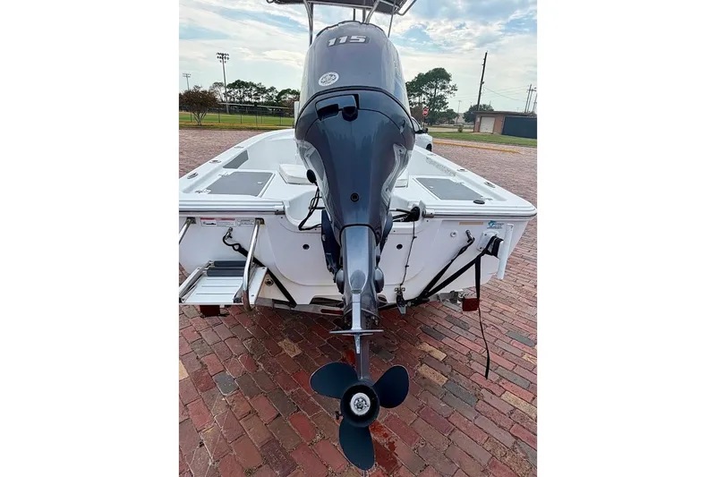 Slide: The Image of 2016 Sportsman Island Bay 20 boat with outboard motor on brick pavement. - 11