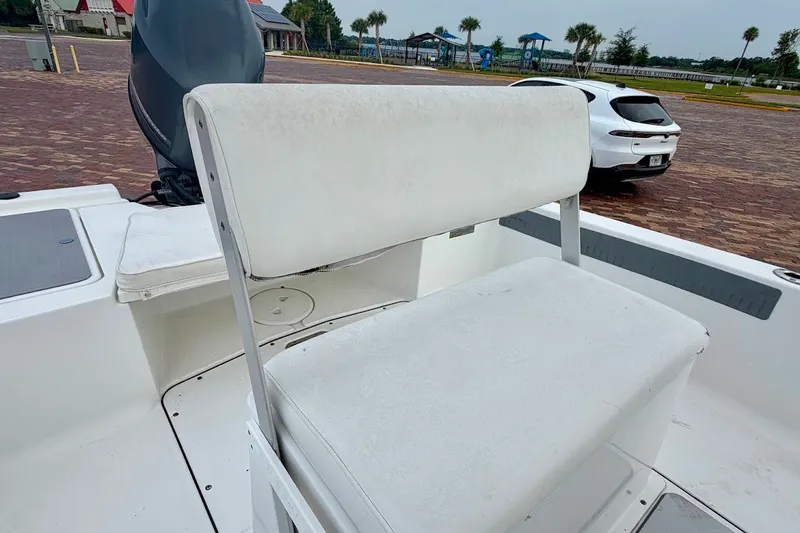 Slide: The Image of 2016 Sportsman Island Bay 20 boat interior with white seating and motor. - 26