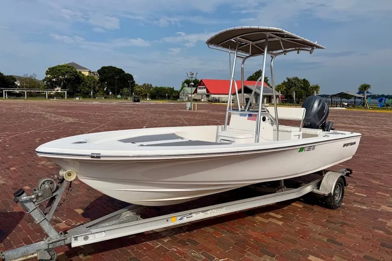 The Image of 2016 Sportsman Island Bay 20 boat on trailer, parked on brick pavement. - 1