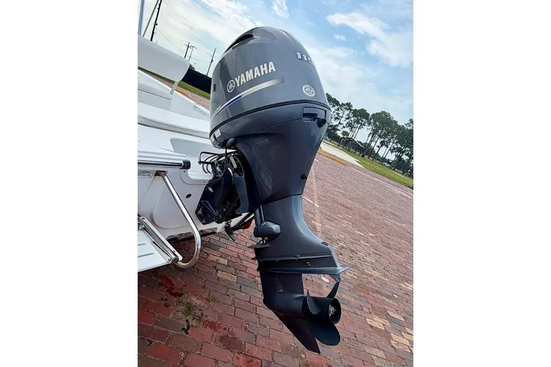 Slide: The Image of 2016 Sportsman Island Bay 20 with Yamaha outboard motor on brick pavement. - 13
