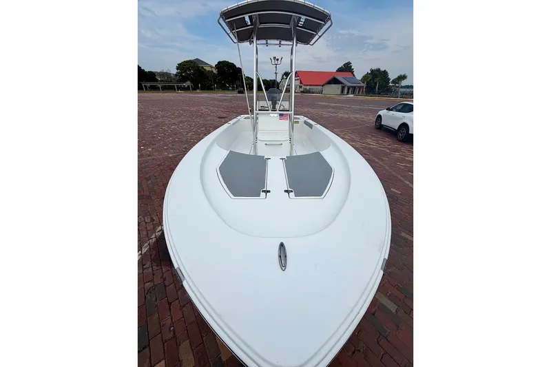 Slide: The Image of 2016 Sportsman Island Bay 20 boat on brick pavement, featuring a sleek white design. - 6