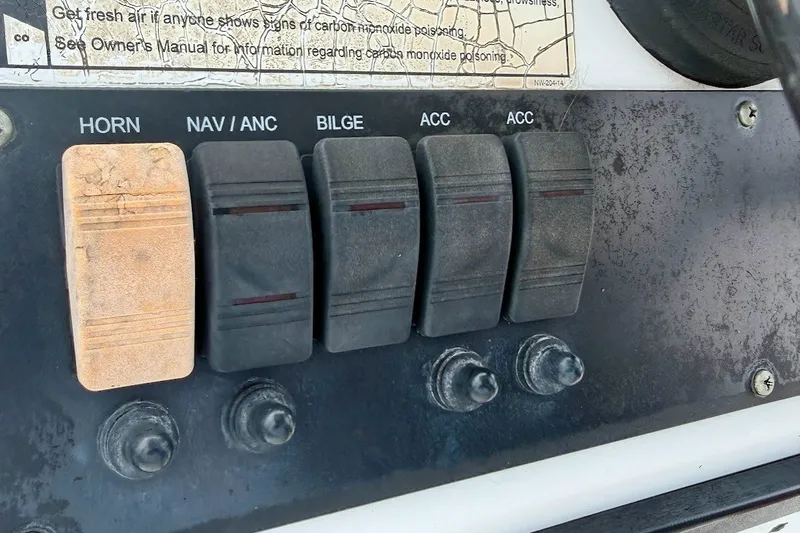 Slide: The Image of Control panel of a 2016 Sportsman Island Bay 20 boat with labeled switches. - 30