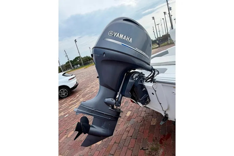 Slide: The Image of Outboard motor on a 2016 Sportsman Island Bay 20 boat, parked on brick pavement. - 10