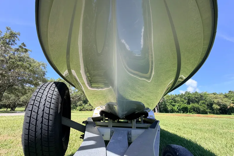 Slide: The Image of 2019 Beavertail Skiffs Vengeance 18' boat hull on trailer, grassy landscape background. - 9