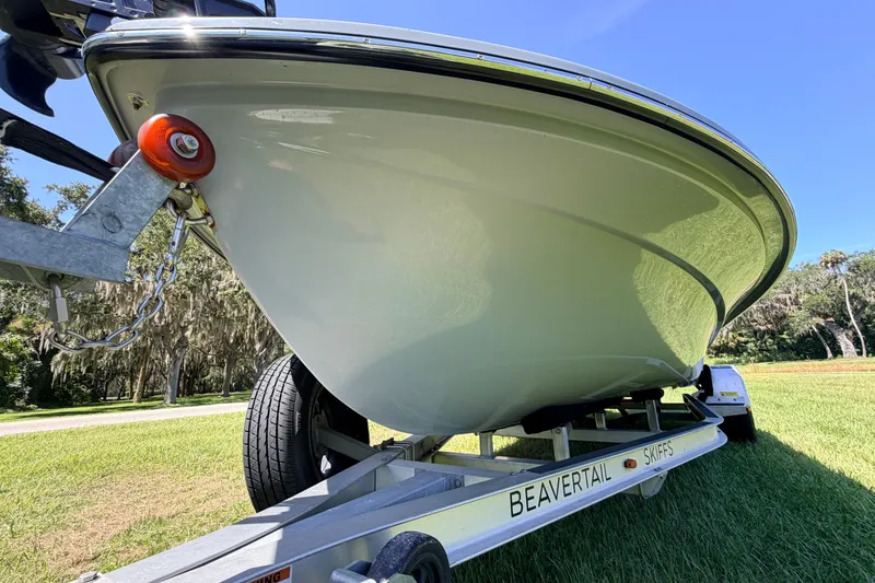 Slide: The Image of 2019 Beavertail Skiffs Vengeance 18' boat on trailer, grassy landscape background. - 8