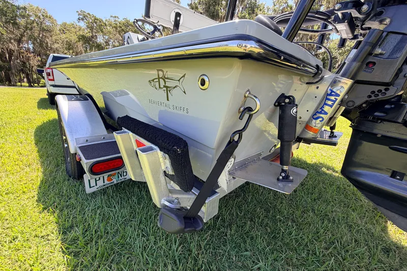 Slide: The Image of 2019 Beavertail Skiffs Vengeance 18' boat on trailer, parked on grass. - 18