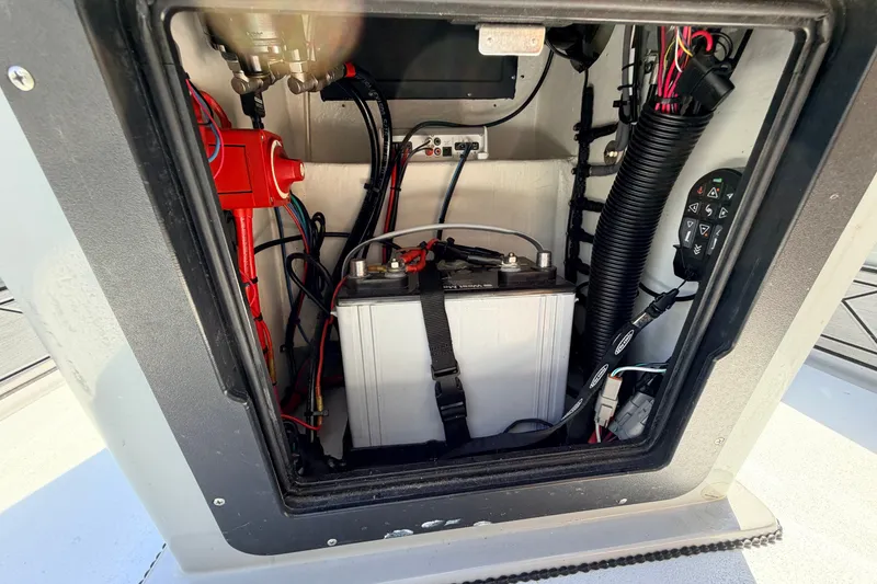 Slide: The Image of 2019 Beavertail Skiffs Vengeance 18' battery compartment with wiring and controls. - 42