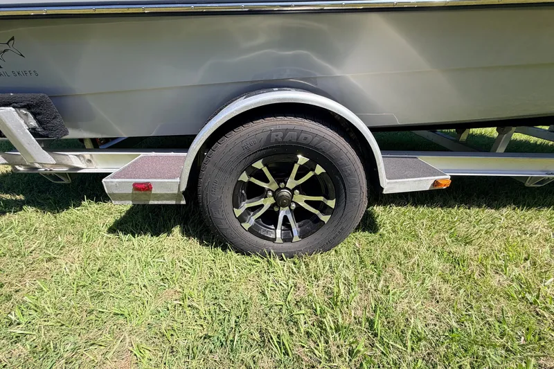 Slide: The Image of 2019 Beavertail Skiffs Vengeance 18' trailer wheel on grass. - 13