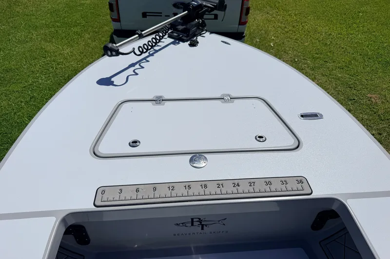 Slide: The Image of 2019 Beavertail Skiffs Vengeance 18' boat deck with ruler and storage hatch. - 21