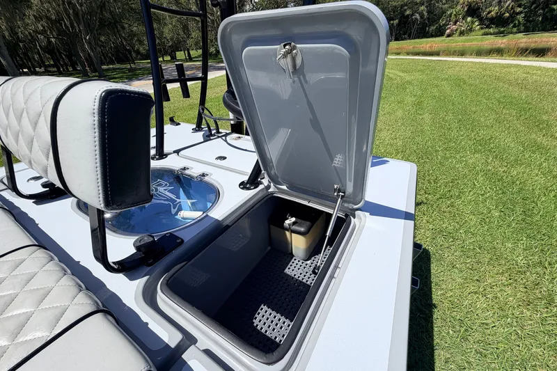 Slide: The Image of 2019 Beavertail Skiffs Vengeance 18' boat with open storage compartment on grassy area. - 56