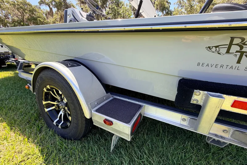 Slide: The Image of 2019 Beavertail Skiffs Vengeance 18' boat on trailer, parked on grass. - 19