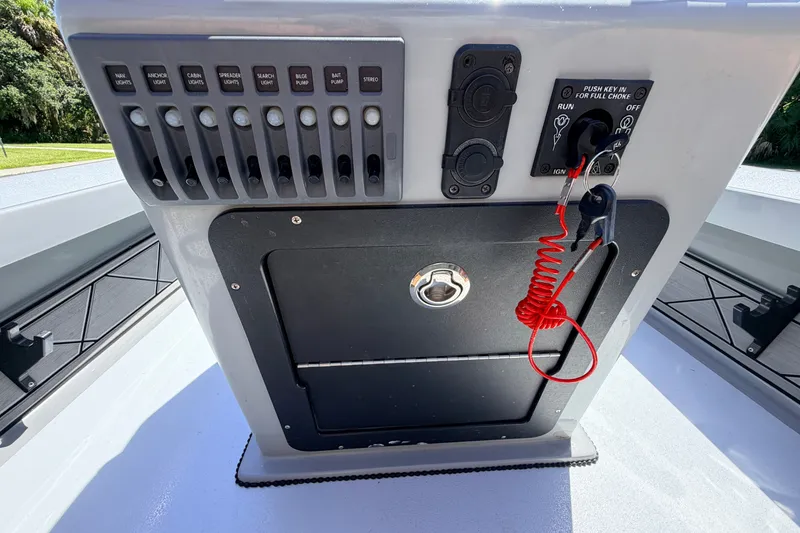 Slide: The Image of Control panel of a 2019 Beavertail Skiffs Vengeance 18' boat with switches and ignition. - 40