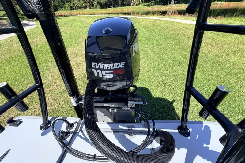 Slide: The Image of 2019 Beavertail Skiffs Vengeance 18' with Evinrude 115 HP engine on grassy background. - 64