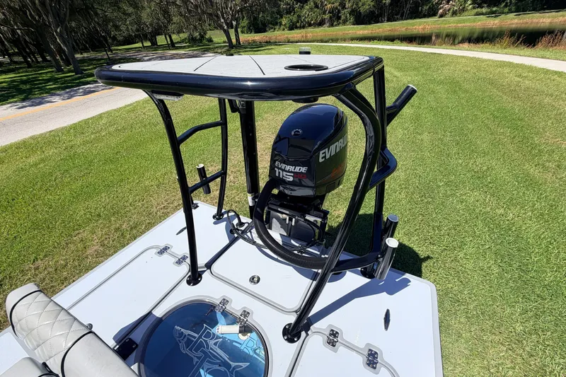 Slide: The Image of 2019 Beavertail Skiffs Vengeance 18' with Evinrude 115 engine on grassy landscape. - 61