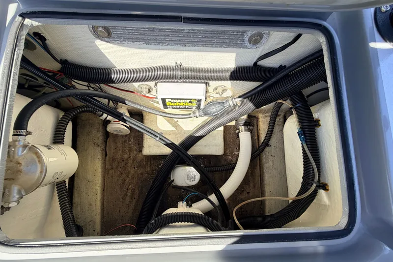 Slide: The Image of 2019 Beavertail Skiffs Vengeance 18' boat compartment with wiring and components. - 59