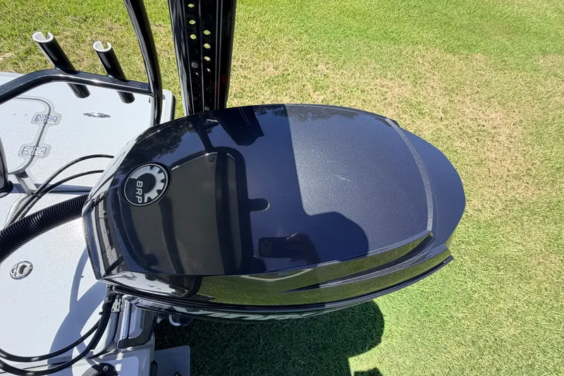 Slide: The Image of 2019 Beavertail Skiffs Vengeance 18' boat engine, BRP logo, on grassy background. - 66
