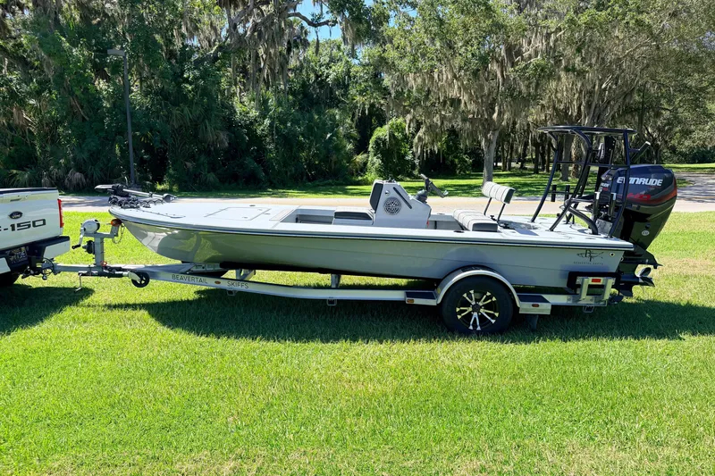 Slide: The Image of 2019 Beavertail Skiffs Vengeance 18' boat on trailer, parked on grass. - 6