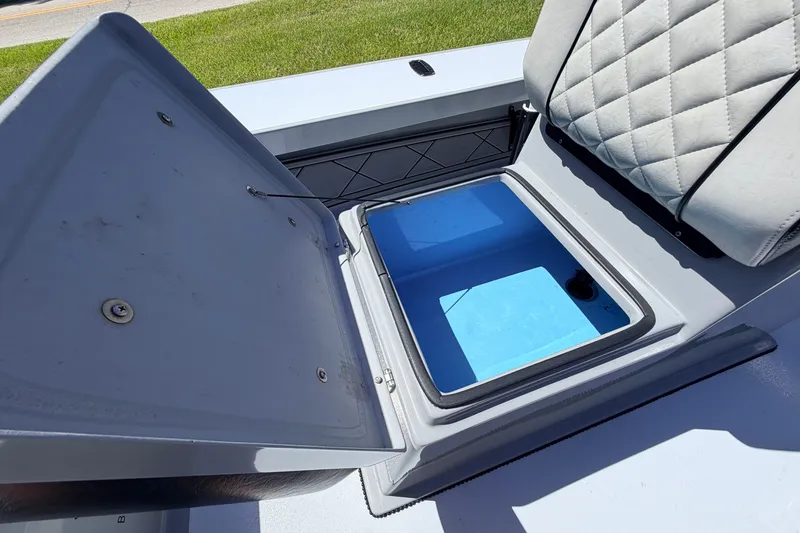 Slide: The Image of Open storage compartment on 2019 Beavertail Skiffs Vengeance 18' boat, featuring quilted seating. - 34