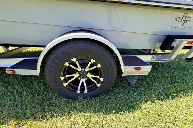 Slide: The Image of Trailer wheel of 2019 Beavertail Skiffs Vengeance 18' on grass. - 20