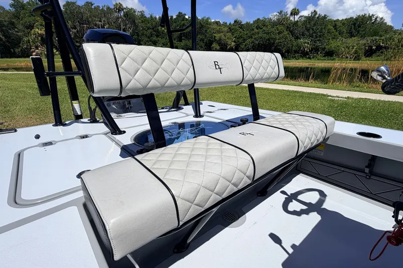Slide: The Image of 2019 Beavertail Skiffs Vengeance 18' boat interior with quilted seating, outdoors. - 49