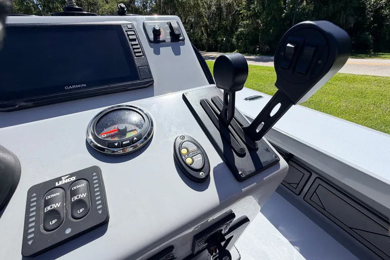 Slide: The Image of 2019 Beavertail Skiffs Vengeance 18' control panel with Garmin display and throttle levers. - 39