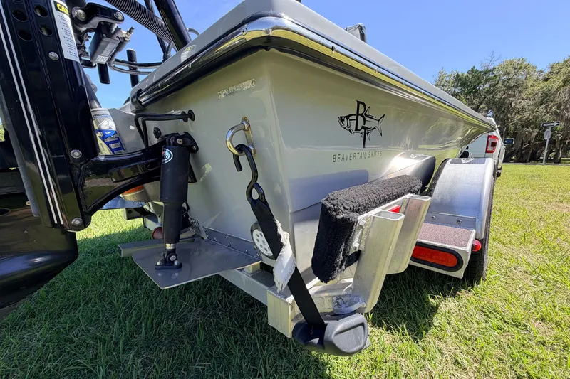 Slide: The Image of 2019 Beavertail Skiffs Vengeance 18' boat on trailer, grassy background. - 14