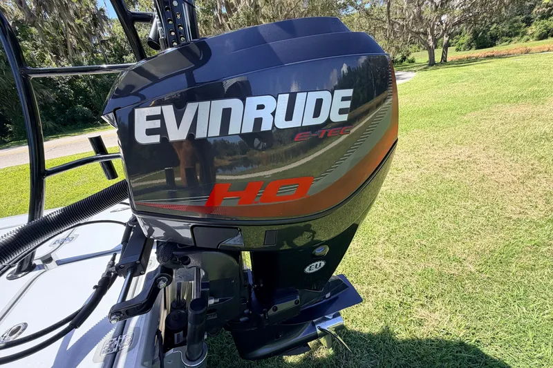 Slide: The Image of 2019 Beavertail Skiffs Vengeance 18' with Evinrude E-TEC HO engine on grassy field. - 65
