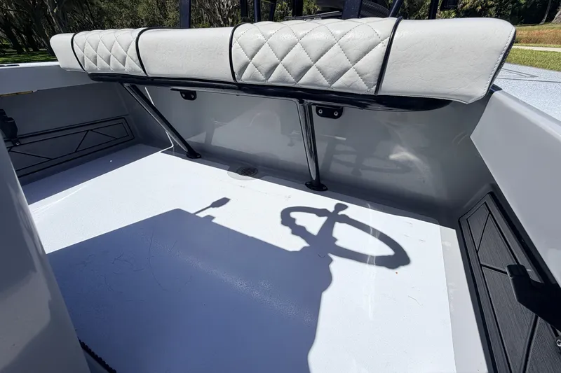 Slide: The Image of 2019 Beavertail Skiffs Vengeance 18' interior with cushioned seating and steering wheel shadow. - 47