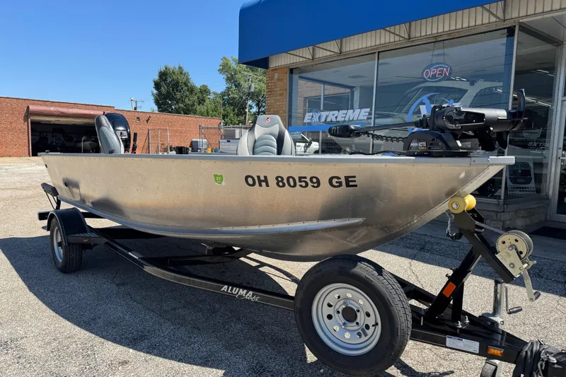 Slide: The Image of 2020 Alumacraft Summit 165 boat on trailer outside dealership. - 6