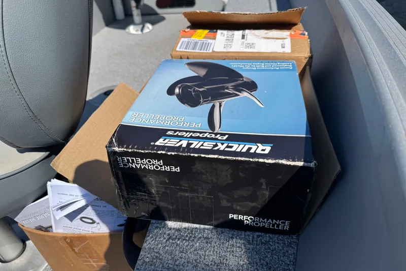 Slide: The Image of Box of Quicksilver performance propeller on 2020 Alumacraft Summit 165 boat seat. - 14
