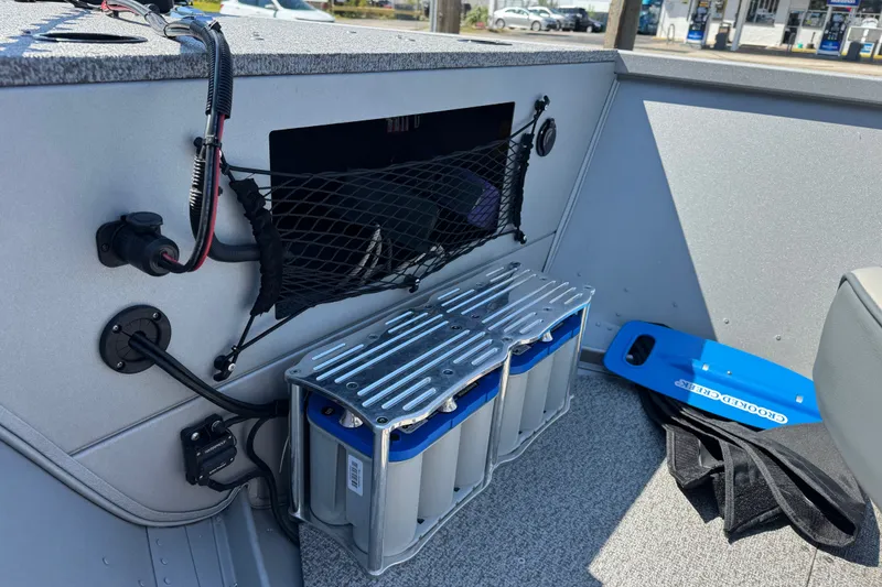 Slide: The Image of Interior of a 2020 Alumacraft Summit 165 boat showing battery compartment and wiring. - 12