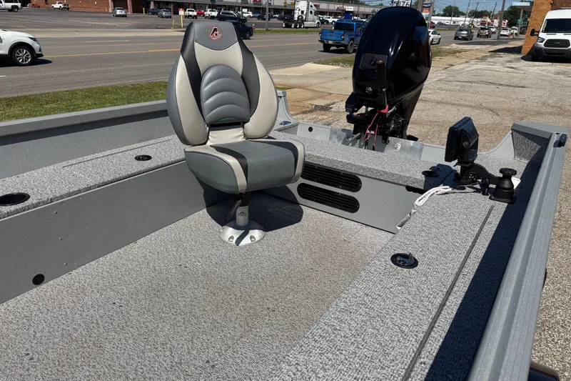 Slide: The Image of 2020 Alumacraft Summit 165 boat with a comfortable seat and motor, parked outdoors. - 13
