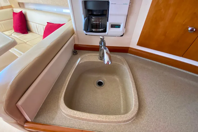 Slide: The Image of 2003 Carver 350 Mariner kitchen with sink, coffee maker, and seating area. - 15